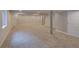 Large finished basement area with gray carpet and columns at 8545 Braun Loop, Arvada, CO 80005
