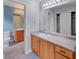 Bathroom features double vanity, large mirror with lighting, and walk-in closet at 8545 Braun Loop, Arvada, CO 80005