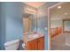 Bright bathroom with blue walls, a single sink vanity, and access to the loft at 8545 Braun Loop, Arvada, CO 80005