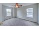 Bright bedroom features neutral carpet, ceiling fan, and double-pane windows at 8545 Braun Loop, Arvada, CO 80005