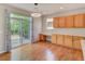 Dining room boasts sliding glass doors with hardwood floors and custom cabinets at 8545 Braun Loop, Arvada, CO 80005