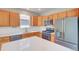 Bright kitchen features stainless appliances, stone counters, and wood cabinets at 8545 Braun Loop, Arvada, CO 80005