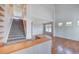 Bright open-concept living space featuring hardwood floors and a staircase at 8545 Braun Loop, Arvada, CO 80005