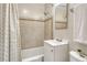 Bright bathroom features tile shower, a white vanity, and a large mirror at 1660 Reed St, Lakewood, CO 80214