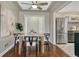 Bright dining area with a modern table set, adjacent to a stainless steel refrigerator at 1660 Reed St, Lakewood, CO 80214