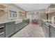 Spacious kitchen with stainless steel appliances, gray cabinets, and view to the dining area at 1660 Reed St, Lakewood, CO 80214