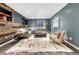 Inviting living room with wooden accent wall, large sectional, and modern decor at 1660 Reed St, Lakewood, CO 80214