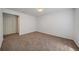 Neutral bedroom featuring neutral carpeting, a white door, and overhead lighting at 16251 E 17Th Pl # C, Aurora, CO 80011