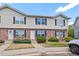 Traditional townhouse exterior with brick and siding, complemented by a well-maintained front yard at 16251 E 17Th Pl # C, Aurora, CO 80011