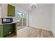 Cozy kitchen space featuring green cabinetry, new appliances and patio access through sliding glass doors at 16251 E 17Th Pl # C, Aurora, CO 80011