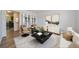 Bright living room with modern furniture, stylish decor, and an open-concept layout showcasing seamless flow to the kitchen at 16251 E 17Th Pl # C, Aurora, CO 80011