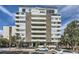 Modern high-rise building features a concrete facade, multiple balconies, mature trees, and convenient street parking at 740 N Pearl St # 503, Denver, CO 80203