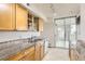 Bright kitchen features granite countertops, stainless steel appliances, and access to the balcony via sliding glass doors at 740 N Pearl St # 503, Denver, CO 80203