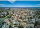 Scenic aerial view of a residential neighborhood, showcasing tree-lined streets and sprawling cityscape in the distance at 13588 W Exposition Dr, Lakewood, CO 80228