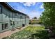 A view of a well-maintained backyard and the exterior elevation of the home at 13588 W Exposition Dr, Lakewood, CO 80228