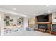 Finished basement with a fireplace, built-in shelving, playroom, and carpeted floor at 13588 W Exposition Dr, Lakewood, CO 80228