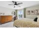 Comfortable bedroom features a ceiling fan, private balcony access, and bright natural light at 13588 W Exposition Dr, Lakewood, CO 80228