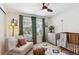 Cozy Bedroom with comfortable sofa and chair offering street views and lots of light at 13588 W Exposition Dr, Lakewood, CO 80228