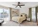 Bright bedroom with a ceiling fan, a private balcony and lots of natural light at 13588 W Exposition Dr, Lakewood, CO 80228