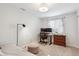 Bright bedroom featuring a modern workstation, neutral décor, and natural light at 13588 W Exposition Dr, Lakewood, CO 80228
