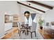 Bright dining area with modern lighting, hardwood floors, open to kitchen, and vaulted ceiling at 13588 W Exposition Dr, Lakewood, CO 80228