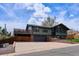 A spacious driveway complements this home featuring a unique architectural design and a welcoming front facade at 13588 W Exposition Dr, Lakewood, CO 80228