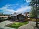 Inviting home featuring a well-manicured lawn, mature trees, ample driveway, and charming facade at 13588 W Exposition Dr, Lakewood, CO 80228