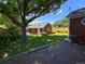 Large backyard featuring green grass, trees, privacy fence, and a storage shed at 1273 S Jackson St, Denver, CO 80210