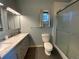 Bathroom with shower stall, oval window and tiled floors at 1273 S Jackson St, Denver, CO 80210
