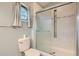 Clean bathroom featuring a glass-enclosed shower, tiled walls, and neutral color palette at 1273 S Jackson St, Denver, CO 80210