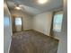 Spacious carpeted bedroom with vaulted ceiling, neutral paint, and two windows at 1273 S Jackson St, Denver, CO 80210