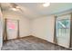 Bright bedroom featuring carpet floors, two windows, light gray walls, and modern ceiling fan at 1273 S Jackson St, Denver, CO 80210