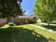 Charming single-story red brick house featuring a well-manicured lawn and mature trees in a residential neighborhood at 1273 S Jackson St, Denver, CO 80210