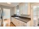 Classic kitchen featuring white cabinetry, granite countertops, and stainless steel appliances at 1273 S Jackson St, Denver, CO 80210