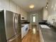 Modern kitchen features stainless steel refrigerator, white cabinets, and dark countertops at 1273 S Jackson St, Denver, CO 80210