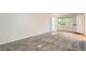 Bright living room with carpet floors, white walls, and a large window that lets in natural light at 1273 S Jackson St, Denver, CO 80210