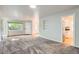 Open concept living room with hardwood and carpet flooring with natural light and built-in shelving at 1273 S Jackson St, Denver, CO 80210