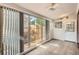 Bright sunroom featuring tile flooring, large windows, and access to an outdoor patio at 1273 S Jackson St, Denver, CO 80210