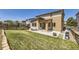 Spacious backyard featuring lush green grass, a cozy covered patio and privacy fencing at 10808 Salida St, Commerce City, CO 80022