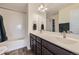 Bright bathroom featuring double vanity, a shower and tub with stylish subway tile surround at 10808 Salida St, Commerce City, CO 80022