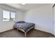 Simple bedroom with neutral walls, carpet, and a single bed, offering a clean and basic space at 10808 Salida St, Commerce City, CO 80022