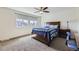 Comfortable bedroom with a ceiling fan, two windows, and a bed with colorful patterned bedding at 10808 Salida St, Commerce City, CO 80022