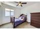 Cozy bedroom with a small bed, dark wood dresser, and a window, creating a comfortable space at 10808 Salida St, Commerce City, CO 80022