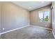 Bright bedroom with neutral paint, carpet, and a window allowing natural light at 10808 Salida St, Commerce City, CO 80022