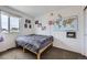 This cozy bedroom features unique wall decor and a comfortable bed with patterned bedding at 10808 Salida St, Commerce City, CO 80022