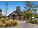 Attractive community clubhouse with stone accents and a covered entrance, surrounded by lush landscaping at 10808 Salida St, Commerce City, CO 80022