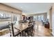 Open concept dining area featuring wood table with seating for eight adjacent to the living area at 10808 Salida St, Commerce City, CO 80022
