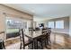Light-filled dining room boasts beautiful wood floors and a view of the covered patio and backyard at 10808 Salida St, Commerce City, CO 80022