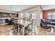 Open concept dining area featuring wood table with seating for eight adjacent to the kitchen at 10808 Salida St, Commerce City, CO 80022