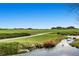 Scenic golf course view with a meandering creek and luxury homes in the background at 10808 Salida St, Commerce City, CO 80022
